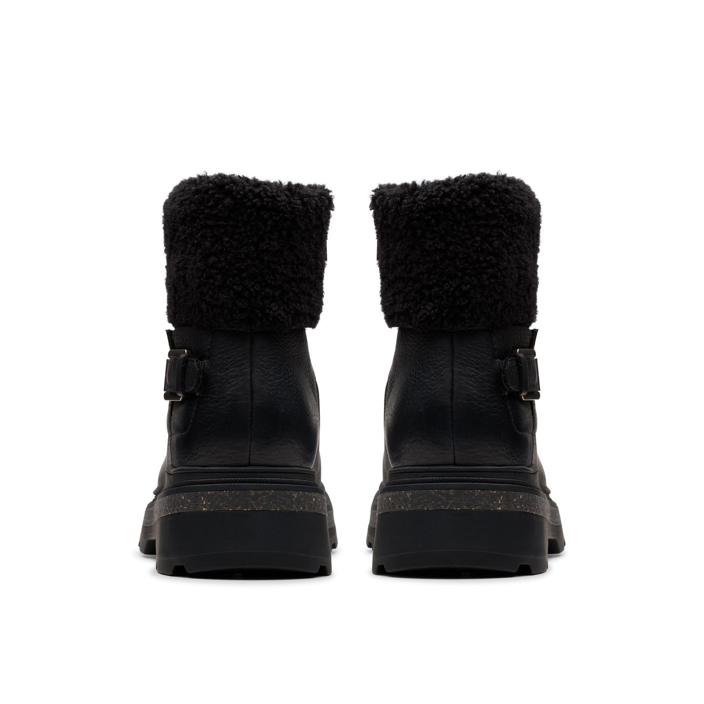Two black, heeled, combat boots with black fluffy collars facing forward.