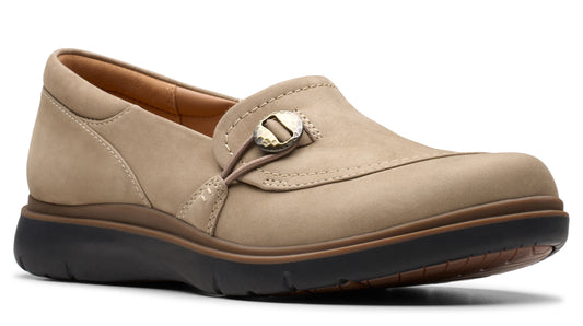 Beige slip-on shoe with a button-like adornment.