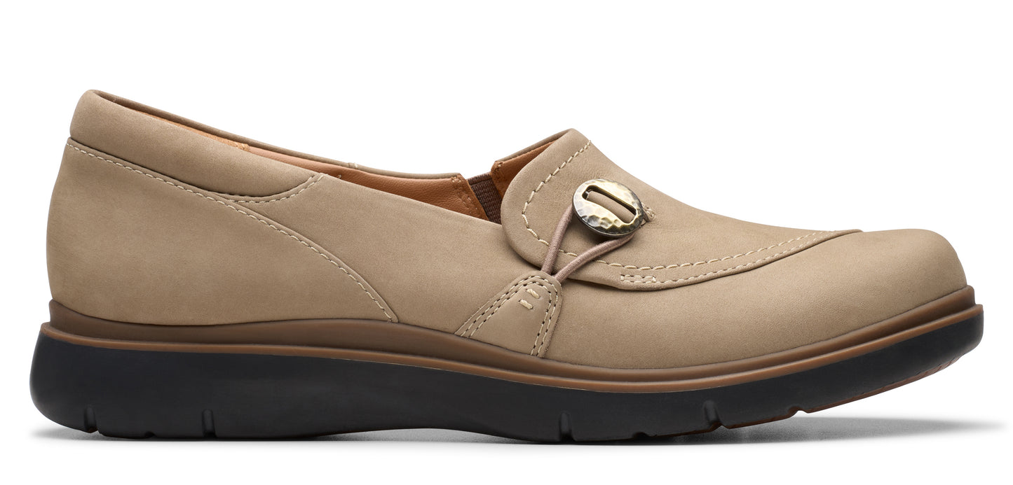 Beige slip-on shoe with a rounded toe and decorative button.