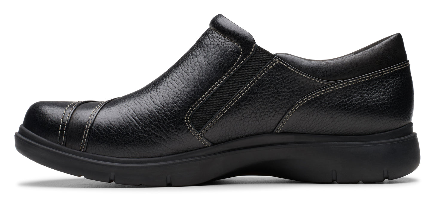 A black leather slip-on shoe with a rounded toe and visible stitching.