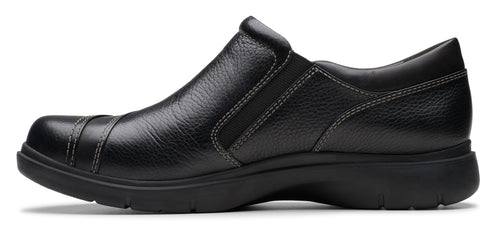 A black leather slip-on shoe with a rounded toe and visible stitching.
