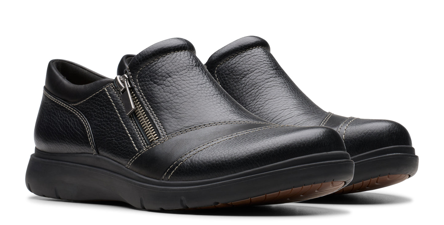 Pair of black leather slip-on shoes with side zipper.