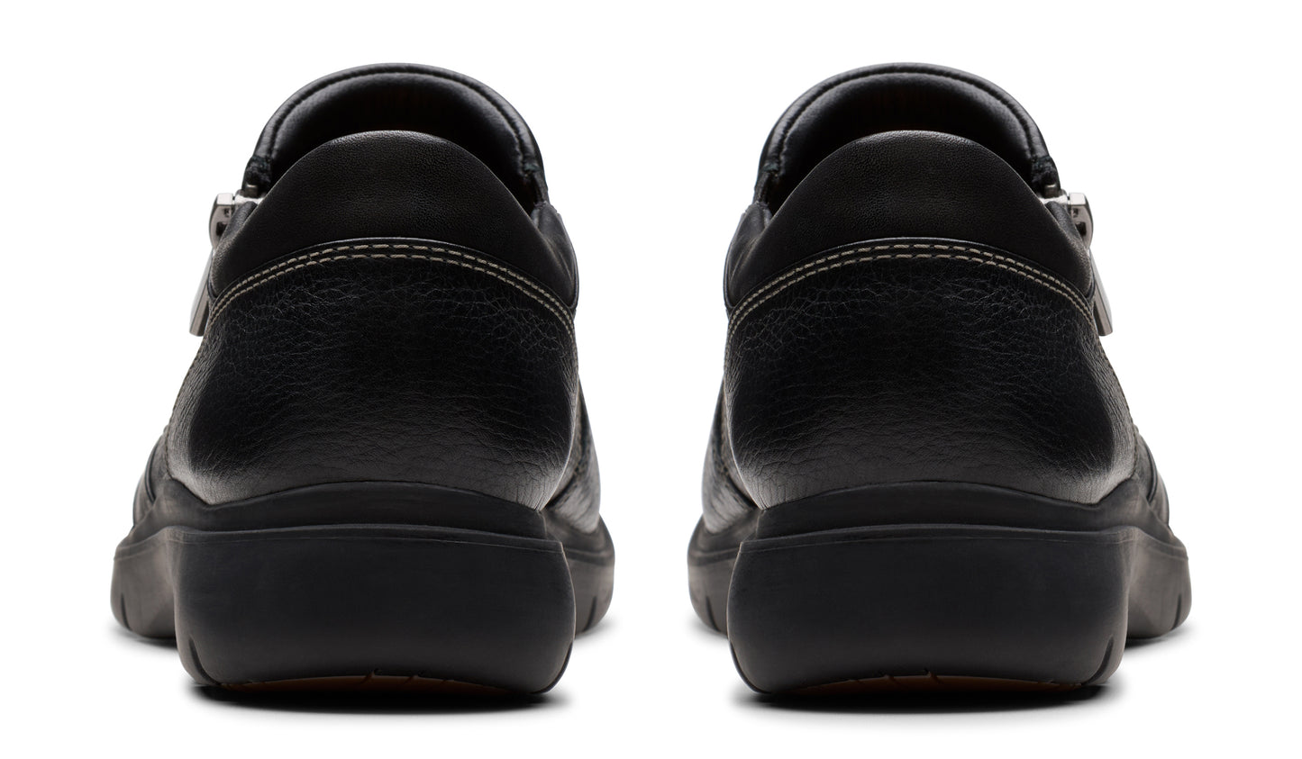 Pair of black leather clogs, rear view.
