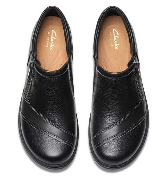 Pair of black leather shoes with visible side zipper.