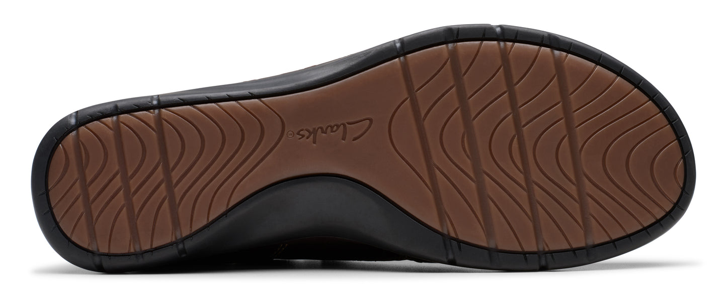 The sole of a shoe, revealing the brand "Clarks" embossed on it and a textured tread pattern.