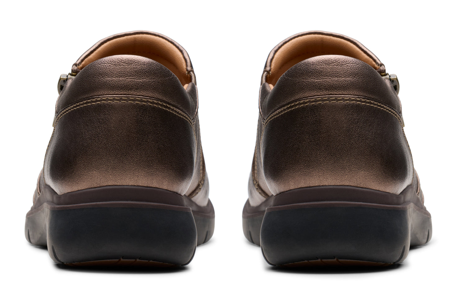 Pair of metallic bronze leather shoes with black soles, viewed from the back.