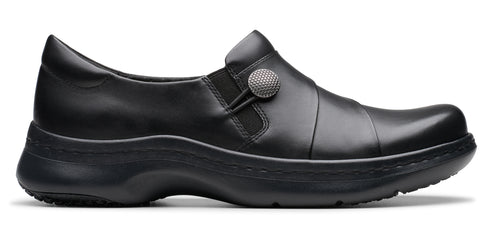 Black slip-on shoe with a round, textured button detail.