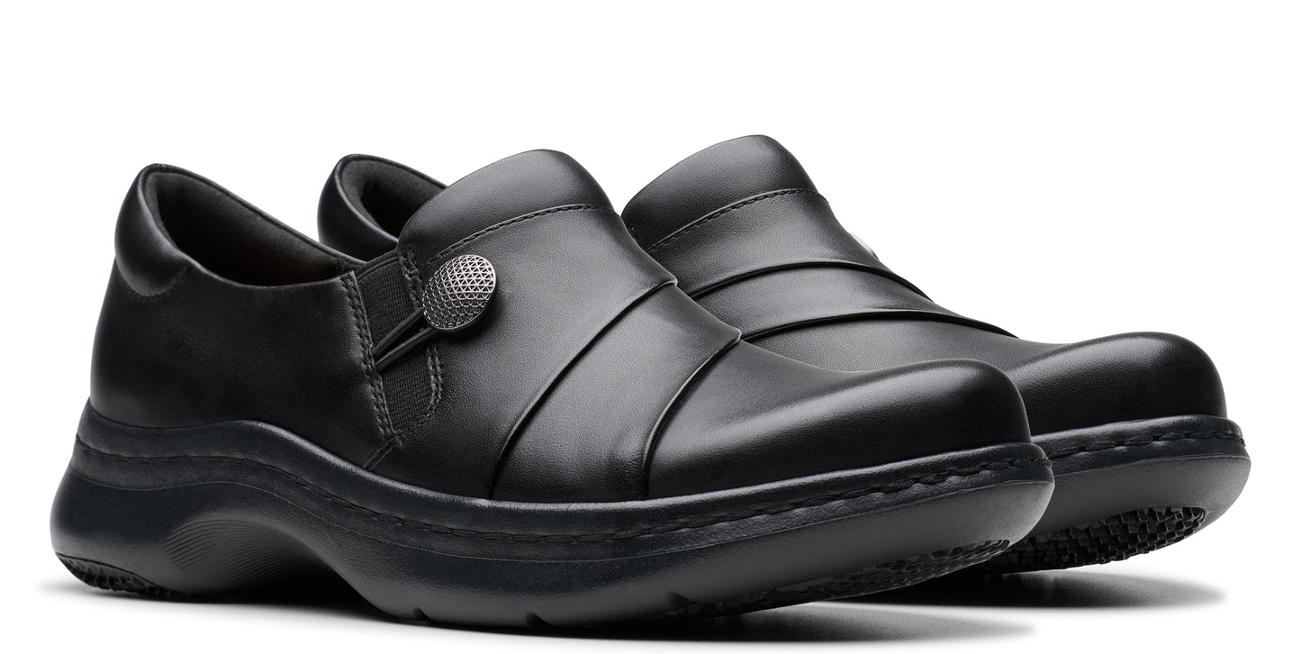 Pair of black leather slip-on shoes with decorative button.