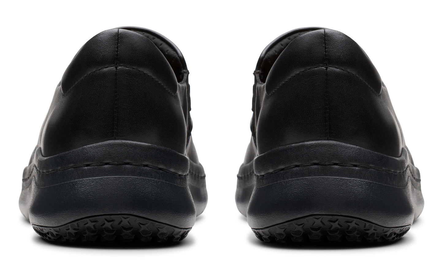 Two black slip-on shoes viewed from the back showing the heel.