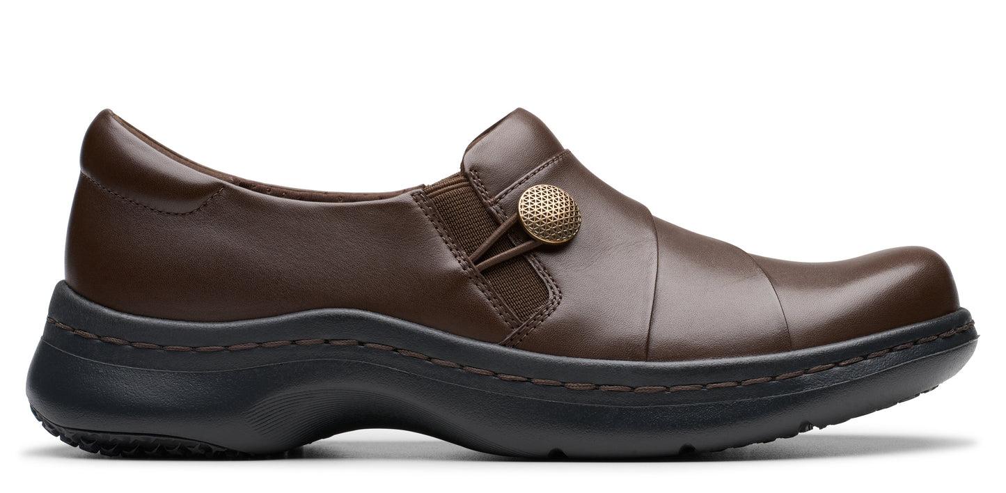 Brown leather loafer with button detail and black sole.
