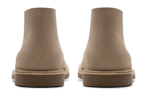 Pair of ankle-high tan boots showing back profile, low heel.