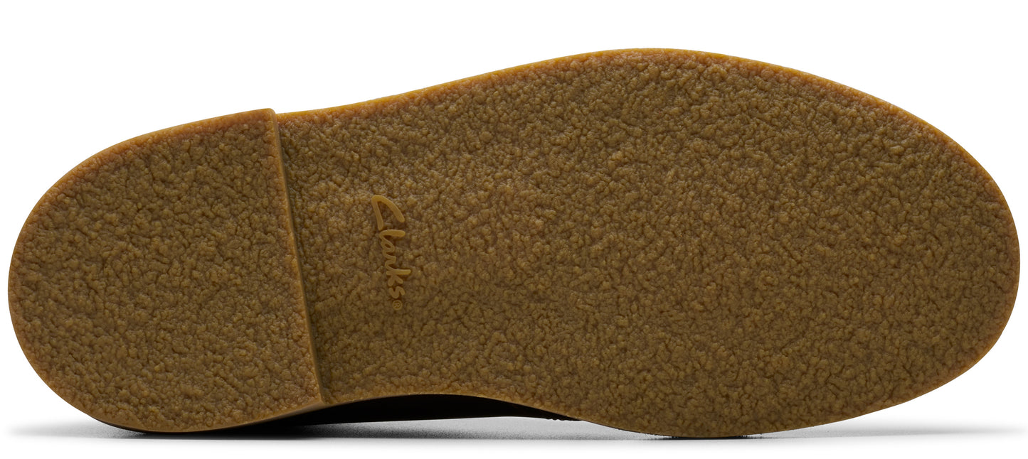 The sole of a shoe showing a ridged texture with a brand logo in the middle.