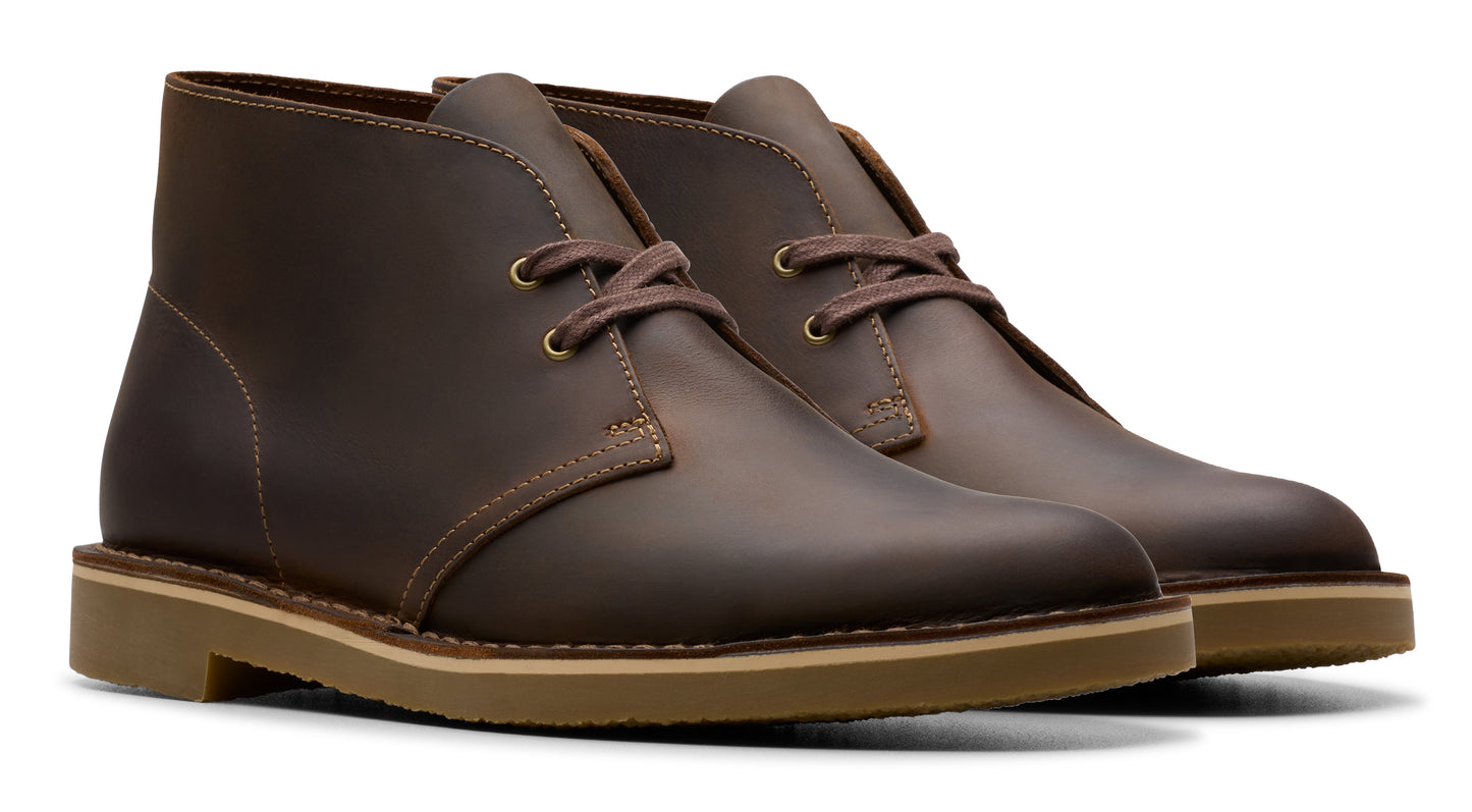 Pair of brown leather desert boots with light brown soles and laces.