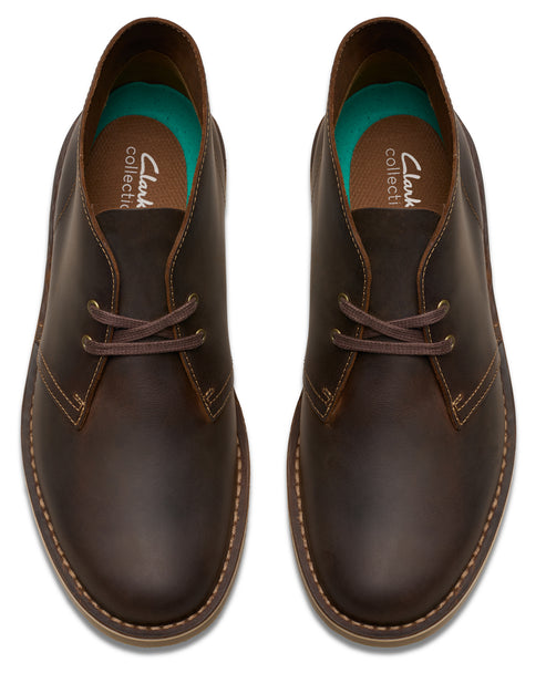 Pair of brown leather chukka boots with dark brown laces.