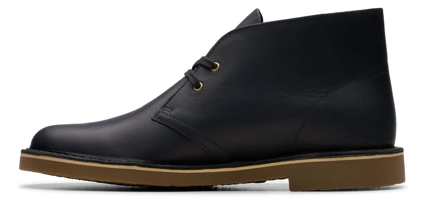 A black leather boot with a brown sole.