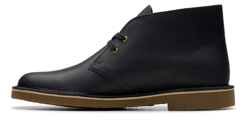 A black leather boot with a brown sole.