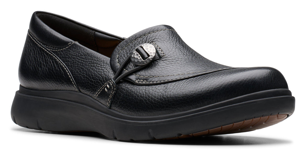 Black slip-on shoe with decorative button.