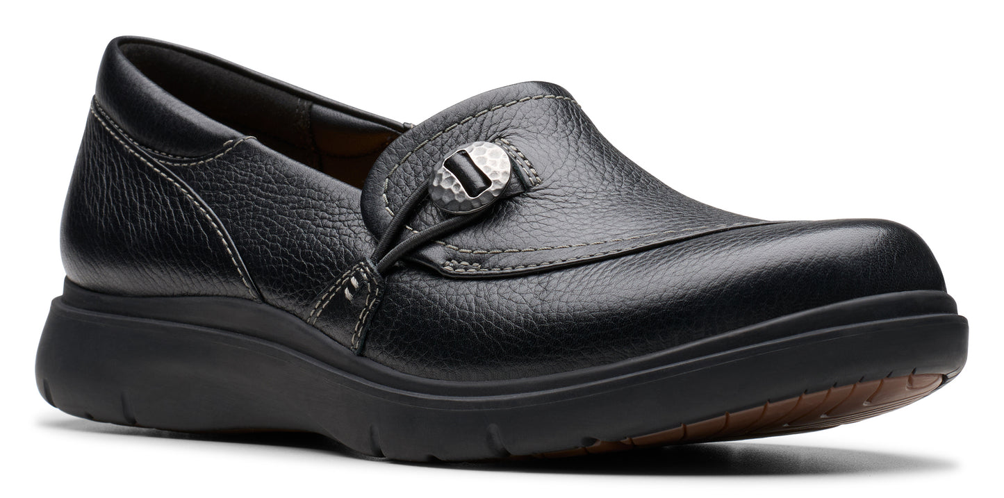 Black slip-on shoe with decorative button.