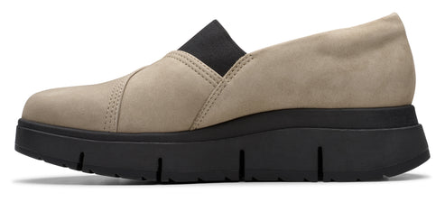 Beige slip-on shoe with black sole and elastic top.
