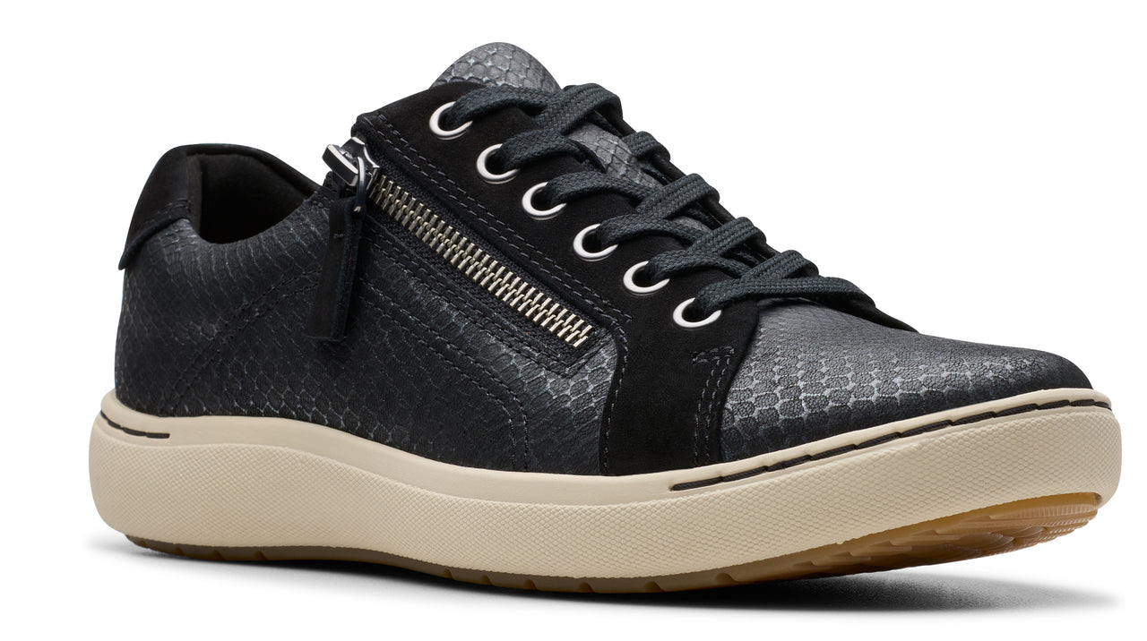 Black sneaker with a side zipper and beige sole.