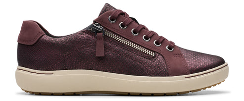 A maroon colored sneaker with a side zipper and beige rubber sole.
