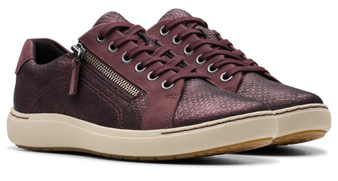 Maroon sneaker with a side zipper on a cream sole