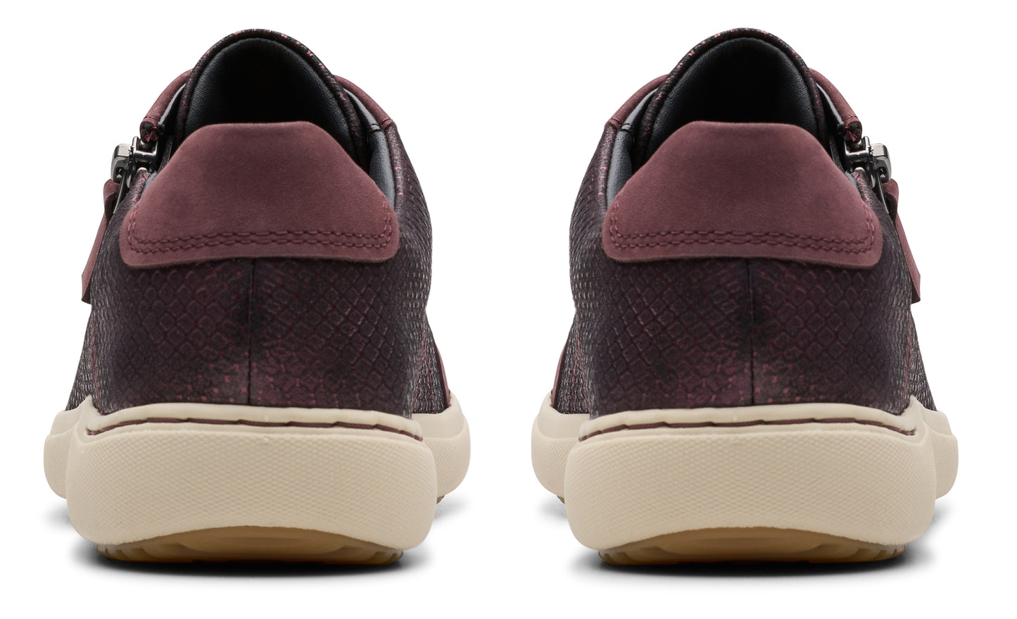 Rear view of dark purple sneakers with tan soles and burgundy heel detail.