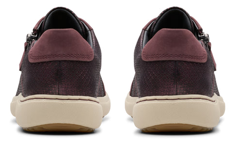 Rear view of dark purple sneakers with tan soles and burgundy heel detail.