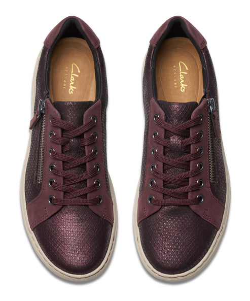 Pair of maroon sneakers with laces and a side zipper.