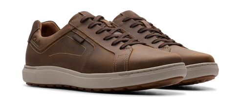 A pair of brown leather sneakers with brown laces and light beige midsoles.