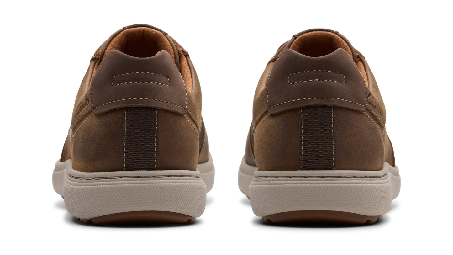 Two brown leather casual shoes with light gray soles, viewed from the back.