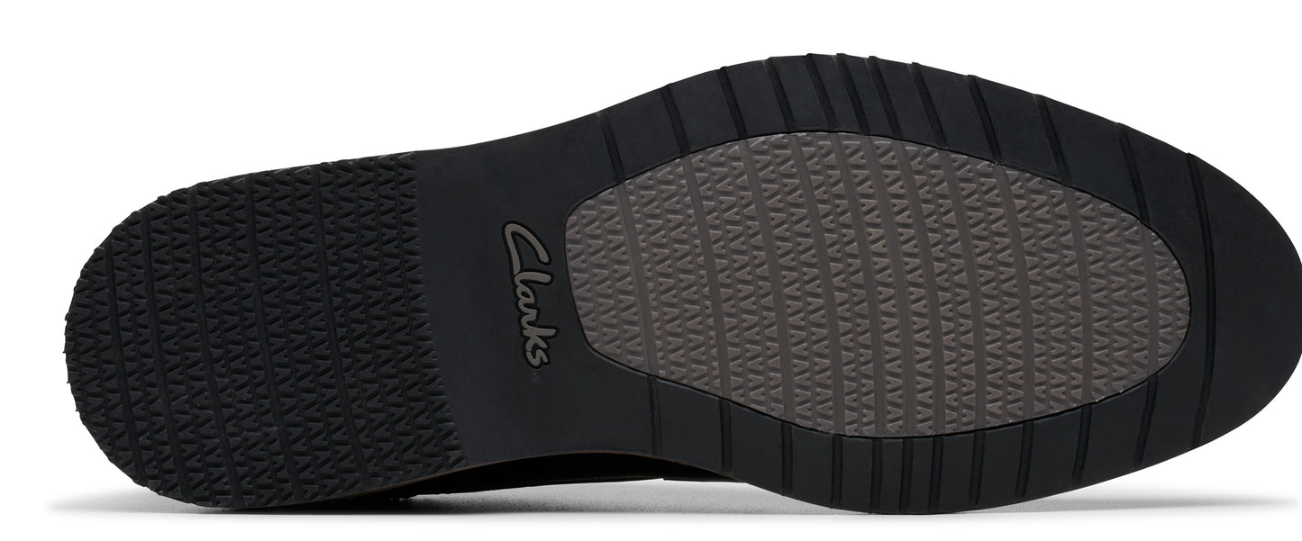 A shoe sole featuring a black tread and an oval-shaped center with a pattern. The 'Clarks' logo is visible on the side.