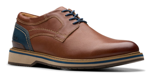 Brown leather oxford shoe with blue laces and accent on the heel.
