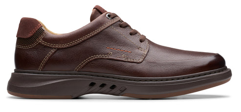 A brown leather dress shoe with a dark sole and a lace-up closure.
