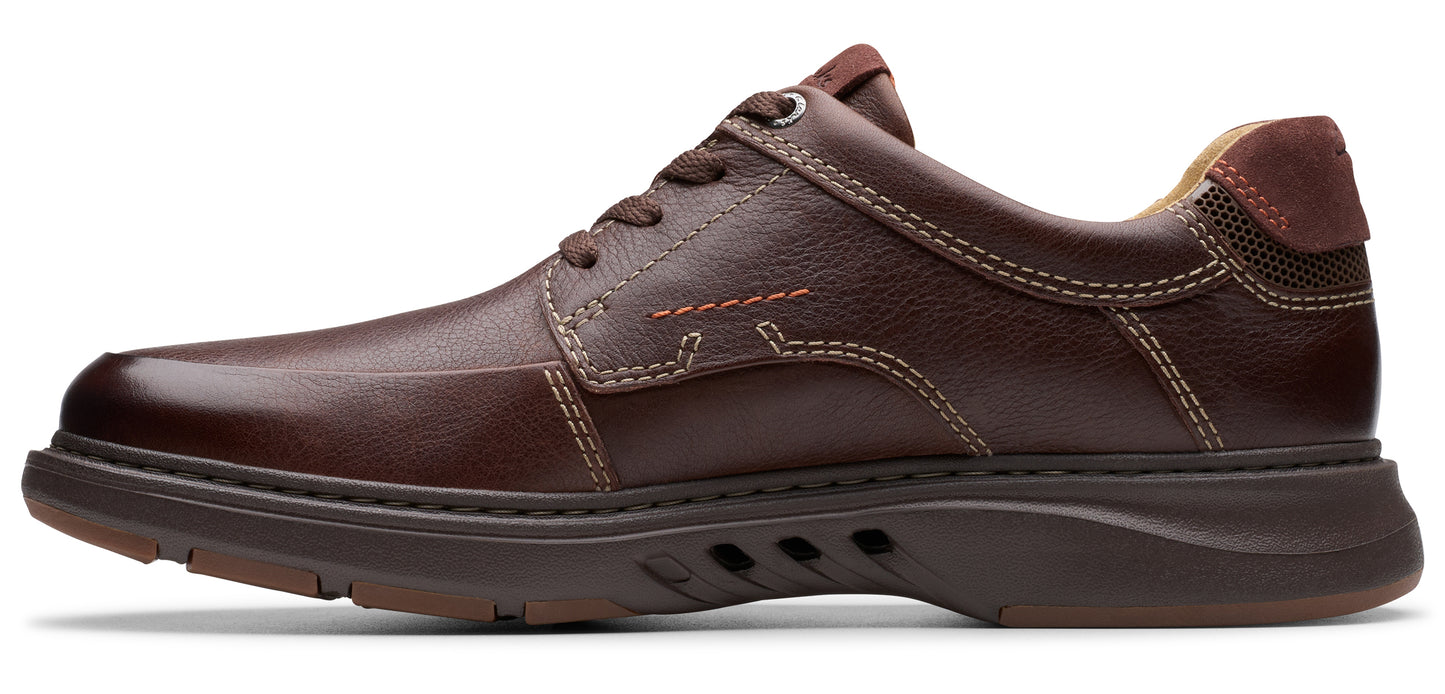 A brown leather dress shoe with a lace-up closure and a rubber sole.