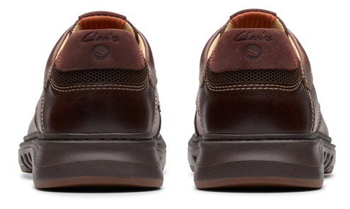 Pair of brown shoes with logo on back.