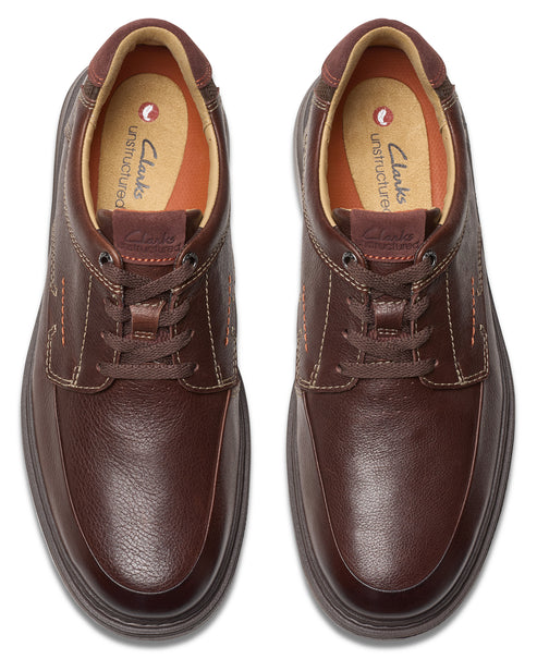 A pair of brown leather lace-up shoes viewed from above, showing inner soles and stitch detailing.
