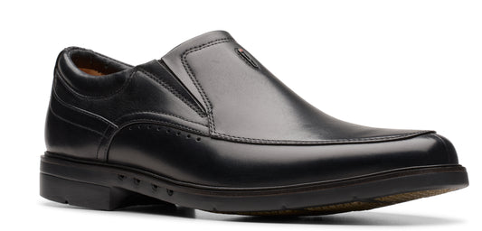 A black, leather slip-on dress shoe with a low heel.