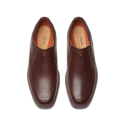 Pair of brown leather slip-on dress shoes, top view.
