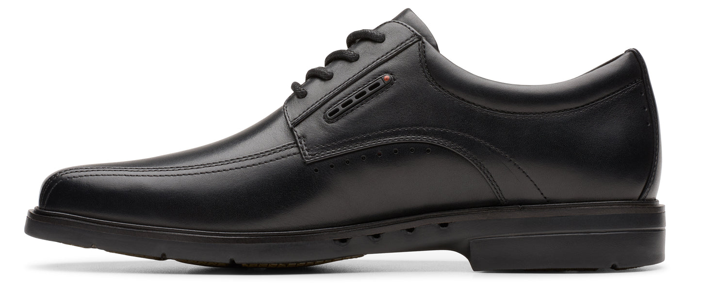 A black leather dress shoe with black laces.