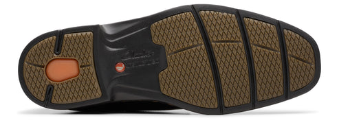 The bottom of a shoe with a brown tread pattern.
