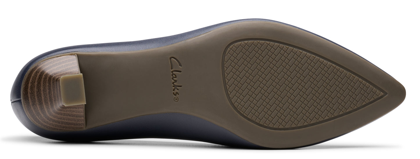 A shoe's underside showing the heel and a brown sole with the brand 'Clarks' printed.
