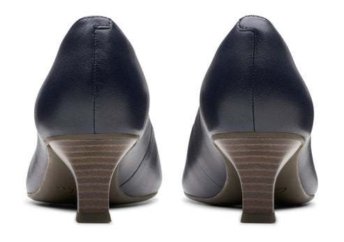 Pair of navy blue leather pumps with low heels.