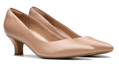 Pair of beige heeled dress shoes.