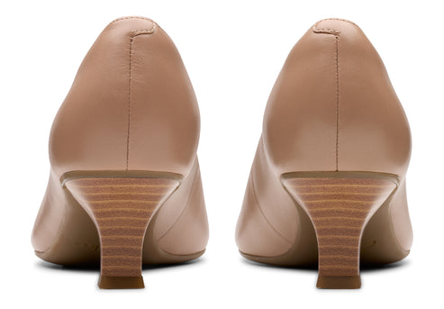 Pair of light tan leather pumps with woodgrain block heels, rear view.