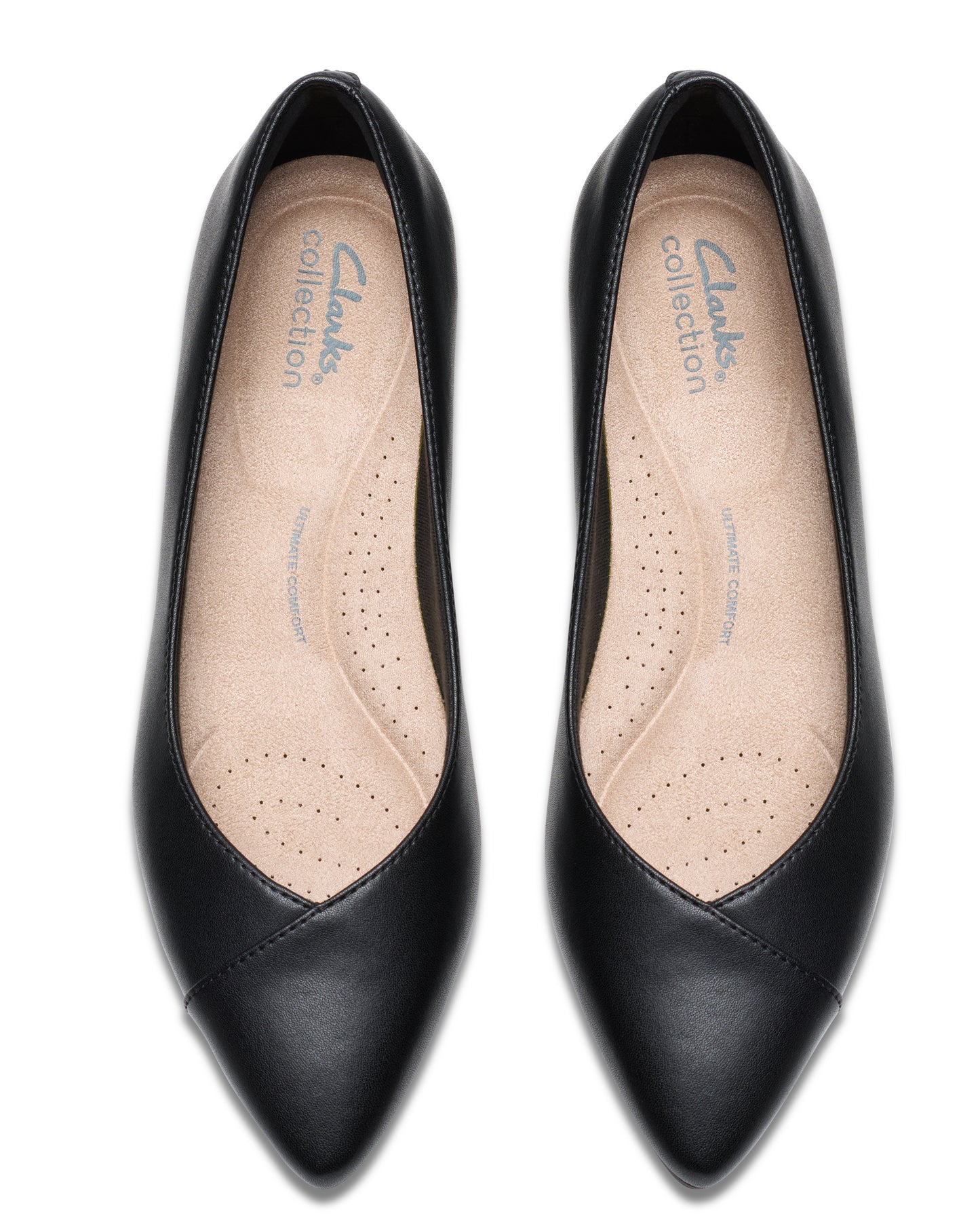 Overhead view of a pair of pointy-toe black leather pumps with an inset insole.