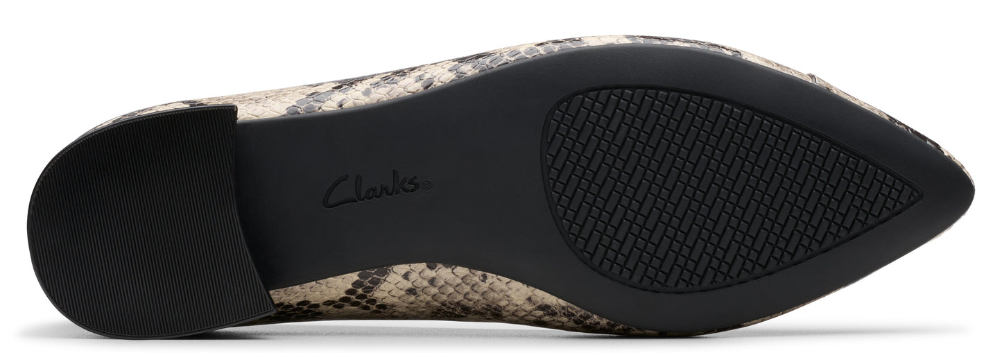 A snakeskin print pointed toe shoe featuring a dark sole with a grip.