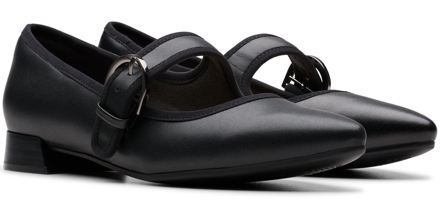 A pair of black, buckled, mary jane shoes.