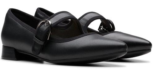 A pair of black, buckled, mary jane shoes.