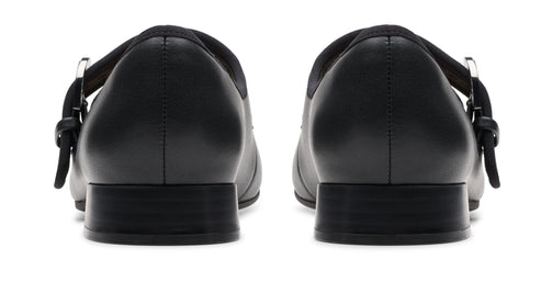 Pair of black Mary Jane shoes with block heels and buckled straps.